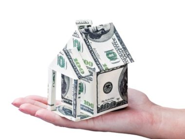 house made of money in hand isolated on white background