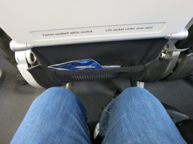 knees next to back of airplane seat