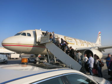 people boarding plane on tarmac