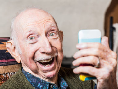 older gentleman taking a selfie with smartphone