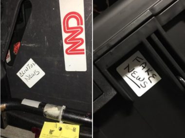 hardcase luggage with fake news sticker