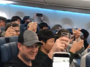 people toasting on plane