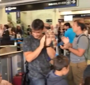 people clapping in airport