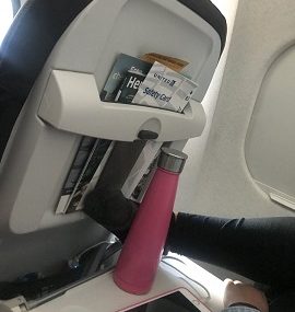 tray table with water bottle and phone