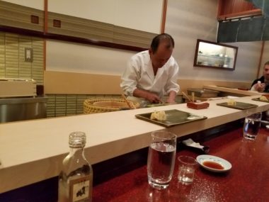 man eating at asian restaurant