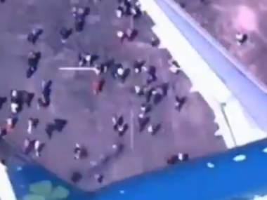 overhead shot of people below flying plane