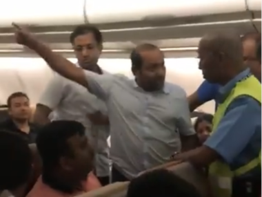 people fighting on plane