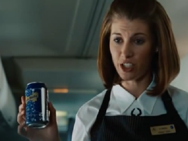 flight attendant holding soda can