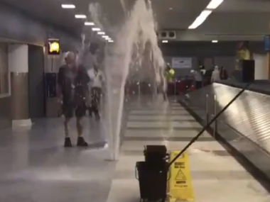 geyser of water in baggage claim