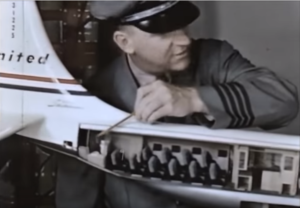 man pointing to room in model united plane