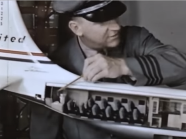 man pointing to room in model united plane