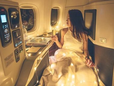 woman in first class with fairy lights