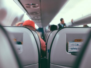 behind man in airplane seat