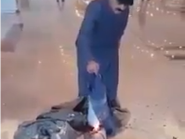 man lighting luggage on fire