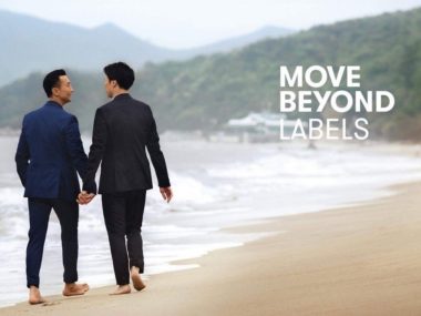 people holding hands walking on a beach