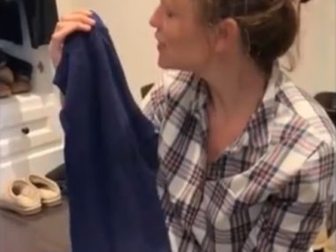 girl looking at shirt