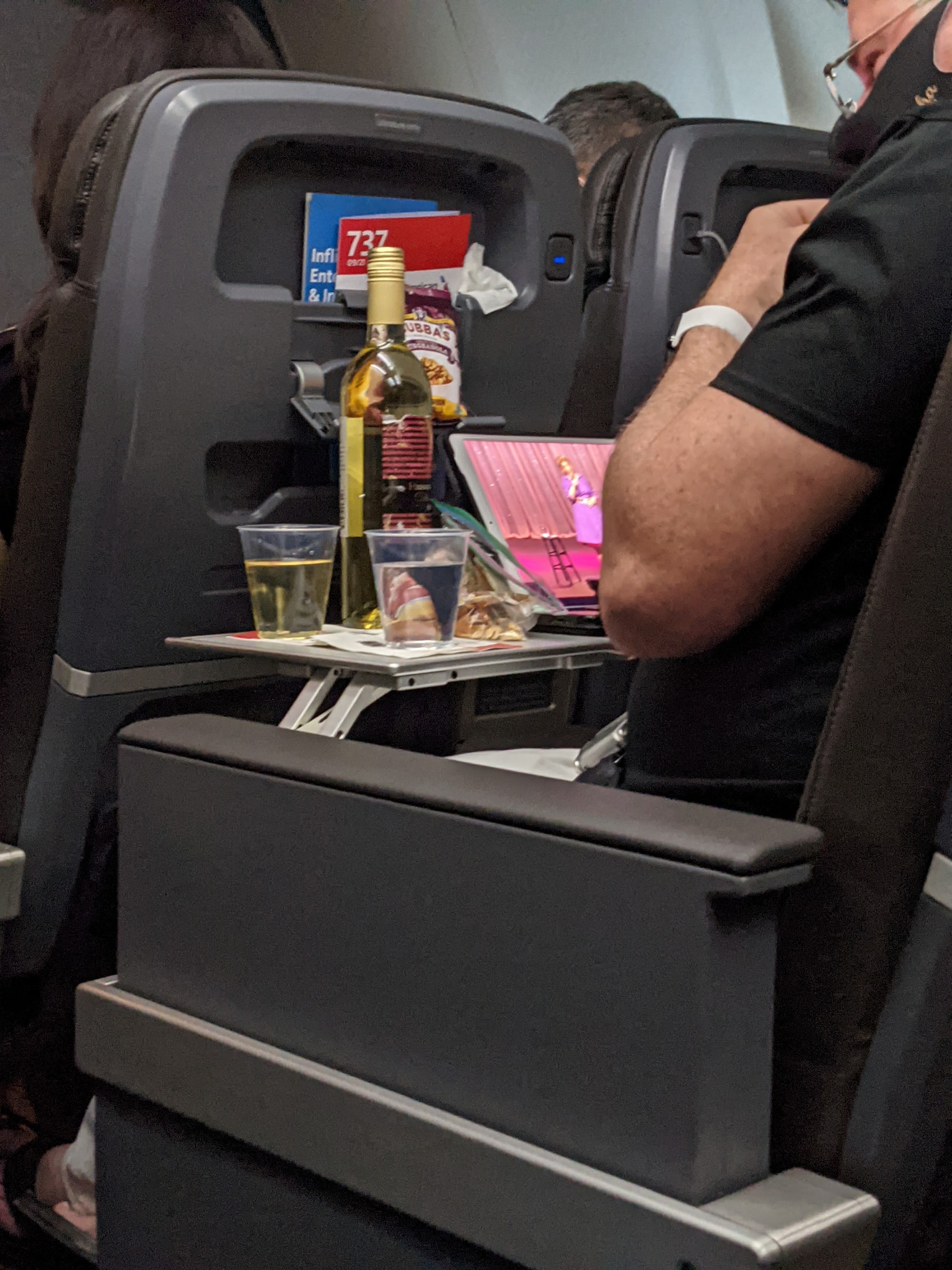 Plastic cup on the table in the plane during the flight. alcohol