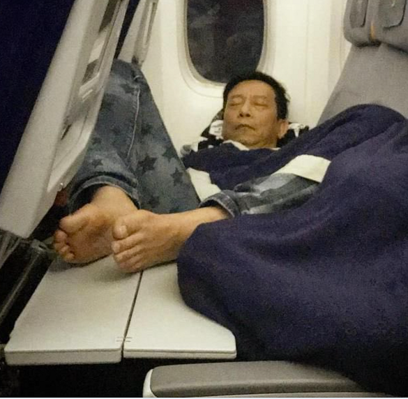 Airplane Passenger Puts Bare Feet On Tray Table - Travel Noire