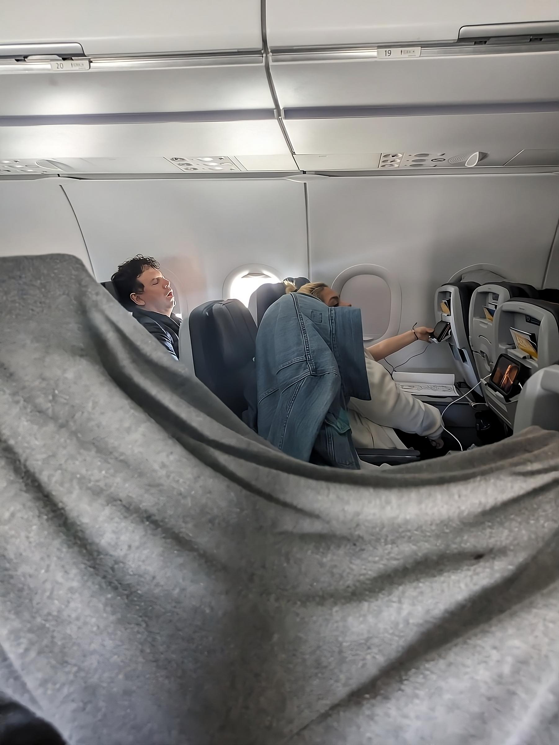 American Airlines Passengers Hide Beneath Blankets To Protect