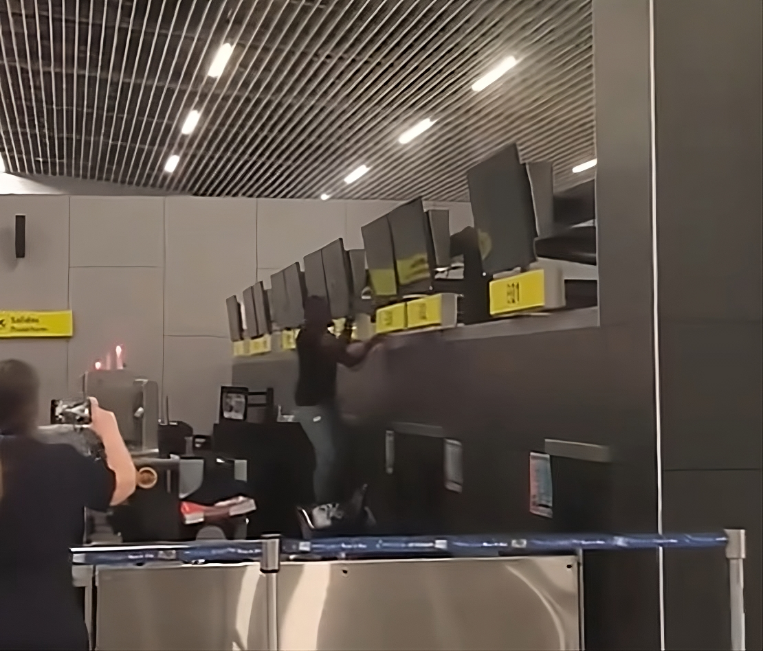 Angry passenger smashes American Airlines check-in counter with hammer after fake ticket scam uncovered