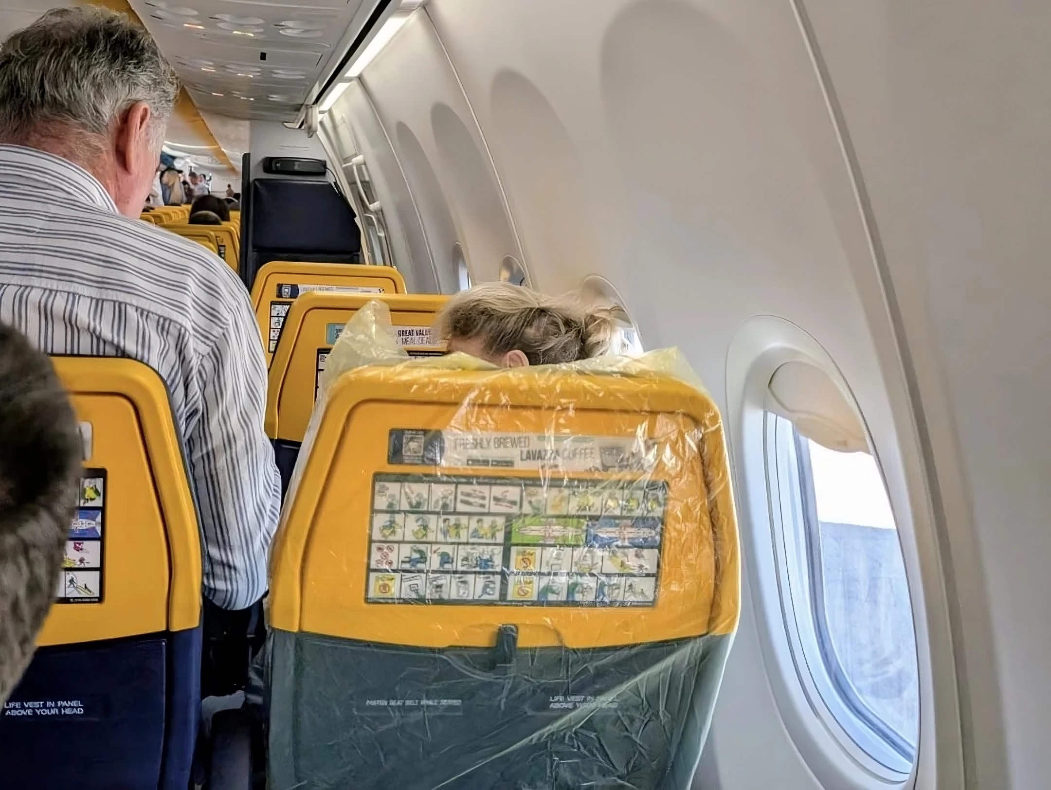 Passenger’s ‘Seat Bag’ Completely Blocks Tray Table, Making It Impossible to Use—What Would You Do? [Roundup]
